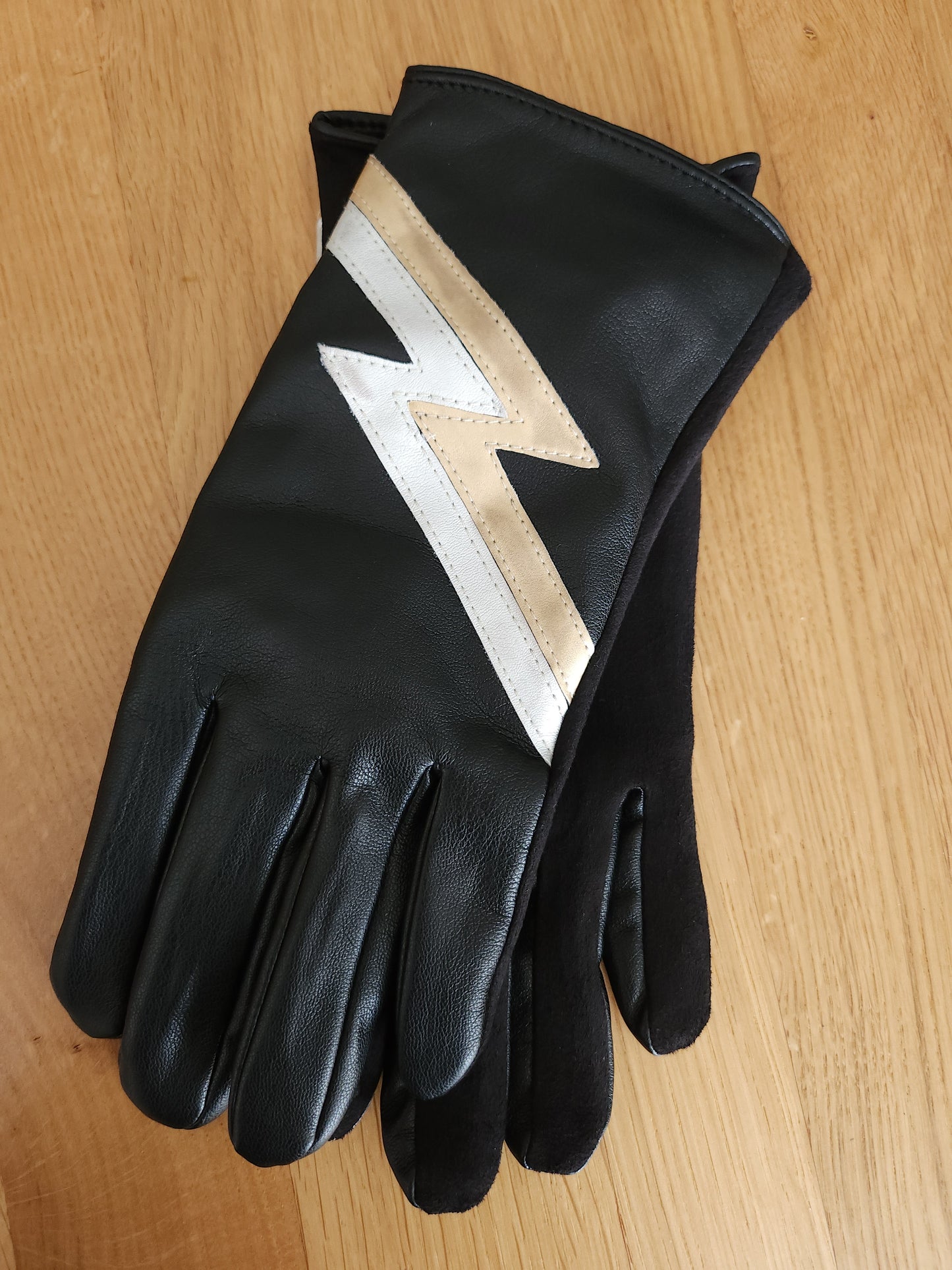 Black gloves with gold lightning bolt